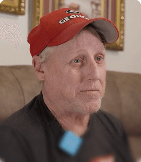 Donald, wearing a red Georgia cap, being interviewed at home